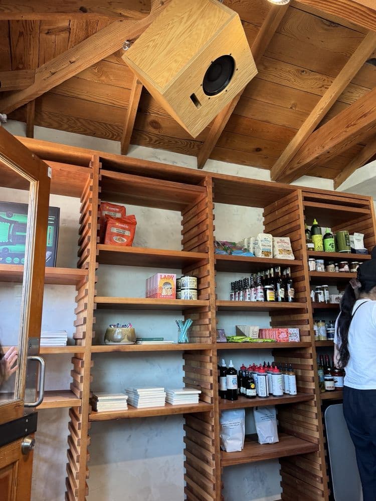 Wooden shelving displaying Community Goods products